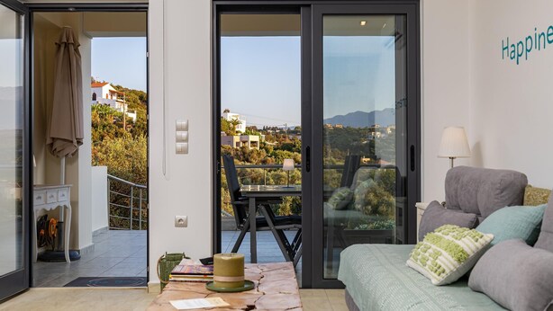 A modern living room with a sofa, a coffee table, and a view of the outdoors. - The Base- Homey, Affordable, in Good Location (Apokoronas)