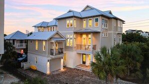 A multi-story house with a balcony and a garage.