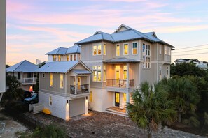 A multi-story house with a balcony and a garage.