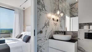 A modern bedroom with a large bed, a bedside table, and a view of the outdoors. - NEW Luxury villa I infinity pool (Starigrad)