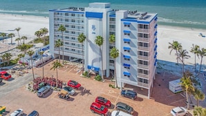 A hotel with a pool, beach view, and parking lot. - Beach Villas # 306 by RedAwning - 15% off through September 2024 (Fort Myers Beach)