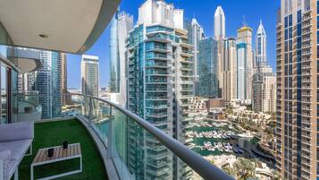 A high-rise building with a view of a marina and other high-rise buildings.