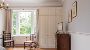 A room with a large window, a wooden chair, a dresser, and a radiator. - Gorgeous 3BD in Oxfordshire - Stunning Countryside (Steeple Aston)