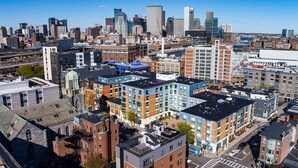 A high-rise urban area with modern buildings, a mix of residential and commercial structures, and a clear view of the city skyline. - Marvelous 2-bedroom apartment in Boston with WiFi (Boston)