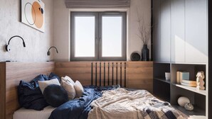 A bedroom with a wooden headboard, a large window, a bookshelf, and a wall-mounted speaker. - Marvelous 2-bedroom apartment in Boston with WiFi (Boston)