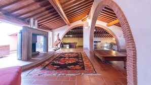 An indoor space with a fireplace, a pool table, and a dining area. - Eighteenth-century Tuscan Villa Tricolle (Fucecchio)
