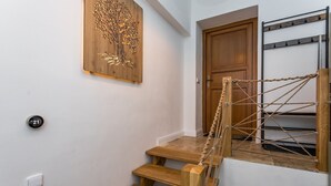 A wooden staircase with a rope barrier, a wooden door, and a wall-mounted shelf. - Vysoke nad Jizerou Kds007 (Vysoké nad Jizerou)