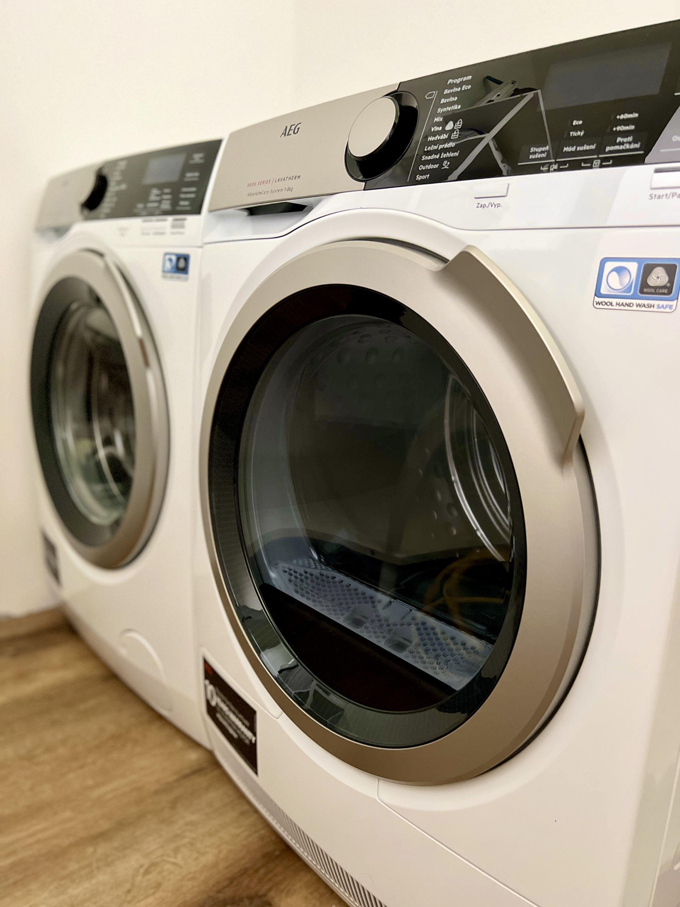 A front view of a front-loading washing machine with a control panel and a front-loading dryer.