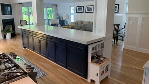 A spacious kitchen with a large island, dark cabinets, and a built-in dishwasher. - Spend Commissioning Week Here:  Walk to Yard, Pool, Hot Tub, Kayaks, and more... (Annapolis)