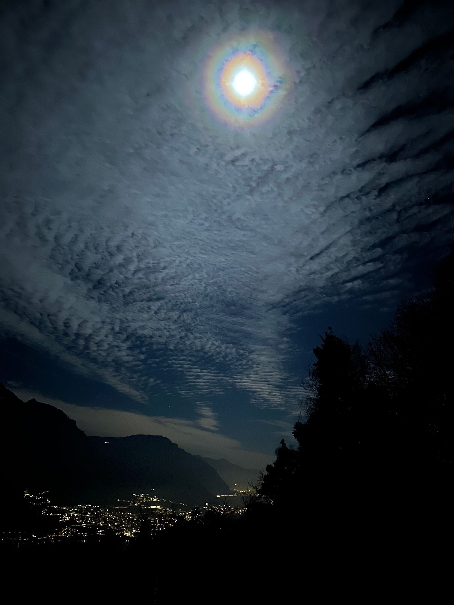 Een nachthemel met een zichtbare maan en verspreide wolken.