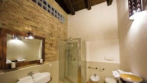 A bathroom with a glass-enclosed shower, a sink, a toilet, and a mirror. - Cagliari Homes (Cagliari)