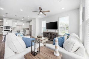 A modern living room with a sofa, coffee table, and a television.