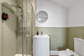 Shower, hair dryer, towels, shampoo