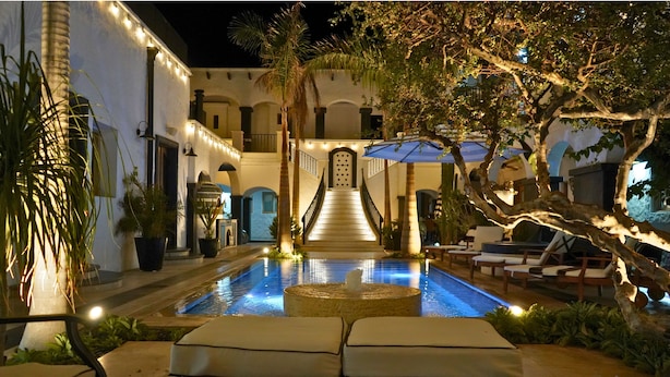 A pool area with lounge chairs and a staircase leading to a building. - Casa 1880 - Adults Only (La Paz)