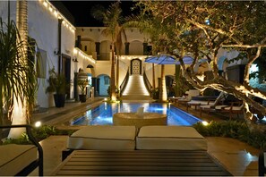 A pool area with lounge chairs and a staircase leading to a building. - Casa 1880 - Adults Only (La Paz)