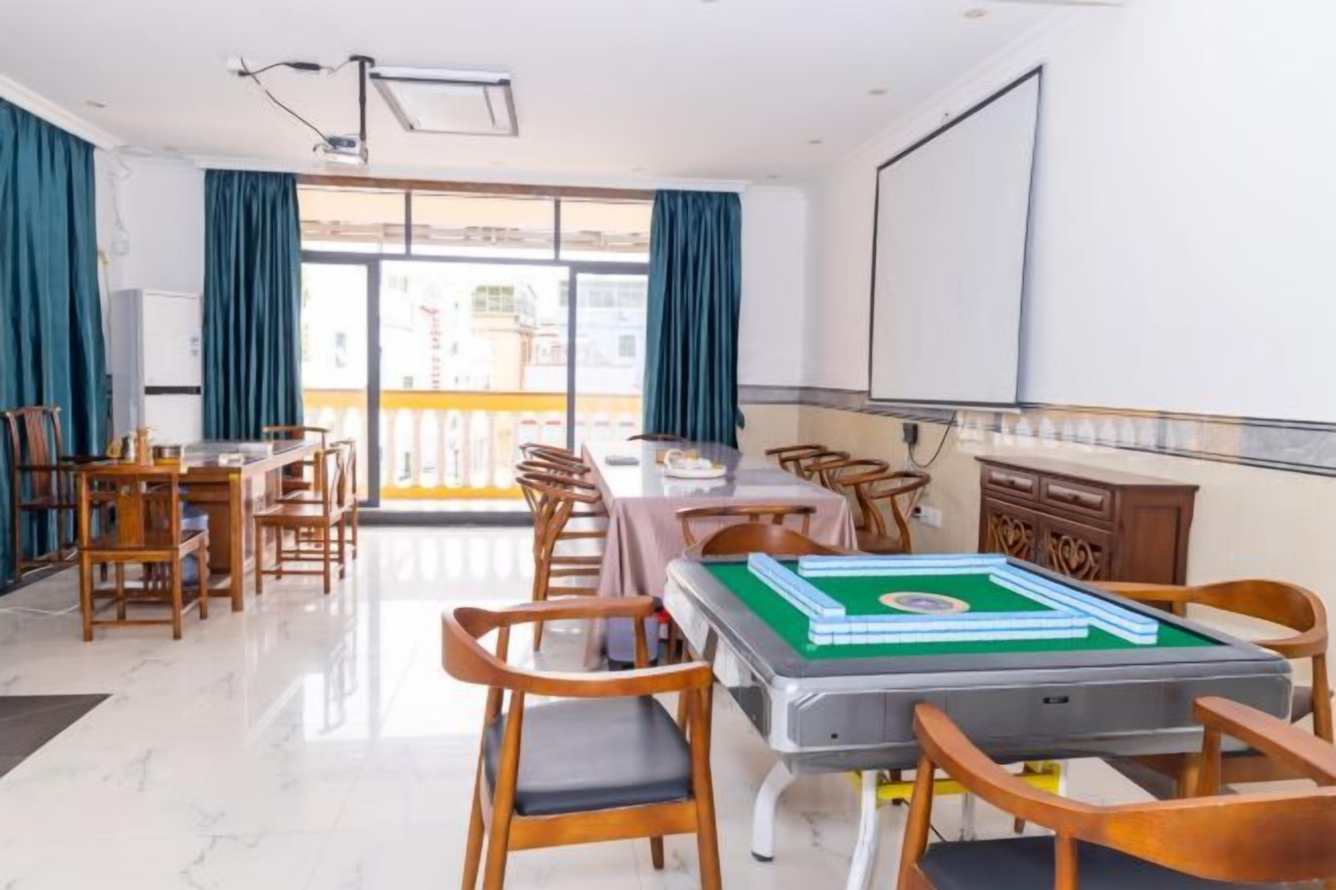 Una habitación de hotel con comedor, mesa de billar y balcón con vistas.