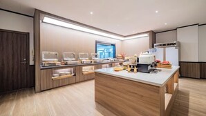 A modern kitchen with built-in appliances, wooden cabinetry, and a central island. - HanTing Hotel (Yan'an University Yangjialing) (Yan'an)