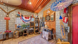 A rustic interior with a Texas-themed sign, wooden furniture, and a vintage decor style.