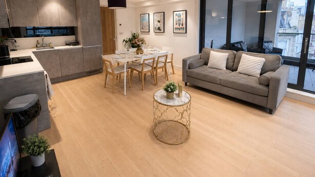 A modern living space with a kitchen, dining area, and seating area.