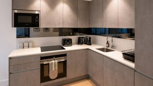 A modern kitchen with built-in appliances, a dishwasher, and a sink.