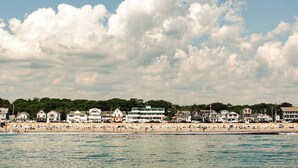 A coastal town with a beach, houses, and a clear sky. - The Nevada (York Beach)