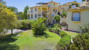 A multi-story building with a courtyard, featuring balconies and satellite dishes. - Cubo's Tennis Paradise Duplex / air conditioning / free wifi / community tennis court (Mijas Costa)