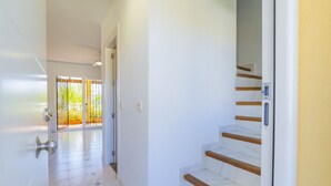 A hallway with a staircase leading to a balcony. - Cubo's Tennis Paradise Duplex / air conditioning / free wifi / community tennis court (Mijas Costa)