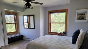 A bedroom with a large bed, two windows, a ceiling fan, and a framed picture on the wall. -  4-bedroom get away with large kitchen, patio and backyard  (Carbondale)
