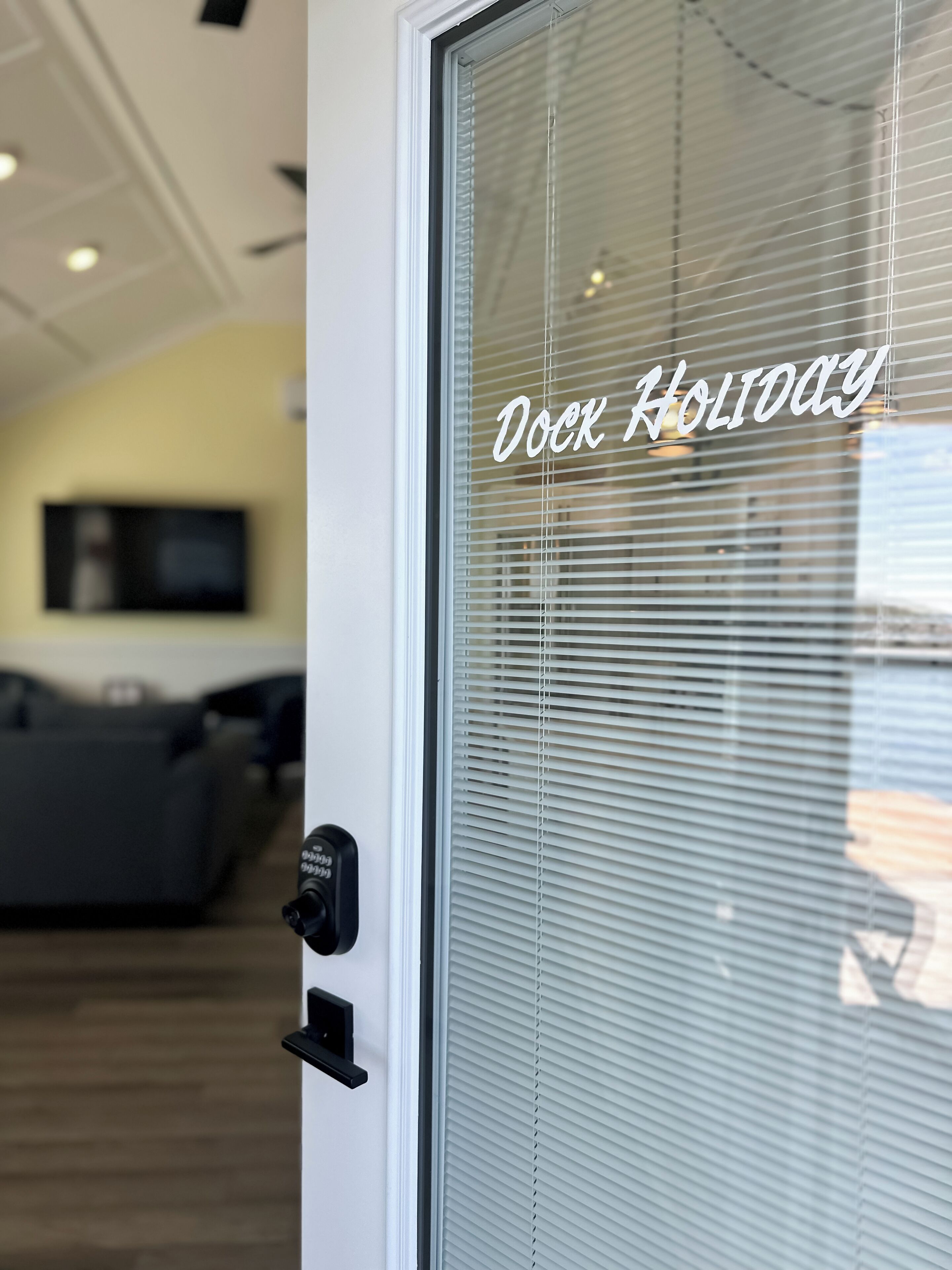 A door with a frosted glass window and a thermostat control.