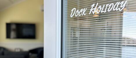 A door with a frosted glass window and a thermostat control.
