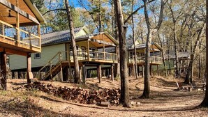 A cabin with a wooden deck and a covered porch. - Paddlewhack Cabin 2 - FlyBridge (Jefferson)