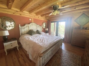 A bedroom with a wooden ceiling, a bed with a white headboard, a nightstand, a dresser, and a window with curtains. - Chase N' Sunsets - NEW Listing, Brow view, between Mentone & Little River Canyon (Fort Payne)