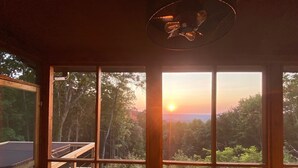 A room with large windows offering a view of a sunset over a forested landscape. - Chase N' Sunsets - NEW Listing, Brow view, between Mentone & Little River Canyon (Fort Payne)