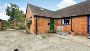 A brick house with a green door, a blue window, and a small porch. - 3 bedroom accommodation in East Orchard, near Shaftesbury (East Orchard, near Shaftesbury)