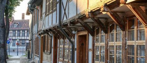 A traditional half-timbered building with exposed wooden beams and a cobblestone street.