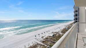A beach view from a balcony with a clear sky, sandy beach, and ocean. - Silver Beach Towers West 1105 | Destin | Beachfront, Outdoor Pool | My Beach Getaways (Destin)