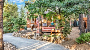 A rustic log cabin with a stone pathway leading to a wooden porch. - The Nest on Towne Trail Big Bear Lake - Hot Tub - Village - (Big Bear Lake)