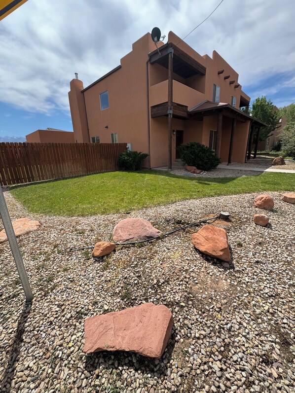 A two-story building with a flat roof and a satellite dish. - 3-bedroom beautiful house in downtown Moab with AC, WiFi, amazing location. (Moab)