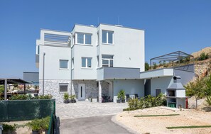 A modern two-story building with a flat roof, large windows, and a stone facade. - Amazing apartment in Podstrana with WiFi (Podstrana)