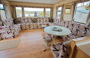 Relax in this inviting space with a large sofa and a convenient dining area.