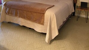 A neatly made bed with a brown cover, two bedside lamps, and a checkered wall pattern. - Central Tellico Village Private Apartment, Experience peace & quiet, Non-smoking (Loudon)