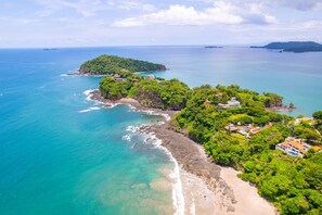 Escape to a tranquil coastal retreat surrounded by lush vegetation and breathtaking ocean views.