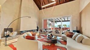 A spacious living area with a fireplace, comfortable seating, and a view of the outdoors. - The Signature Penthouse (Marbella)