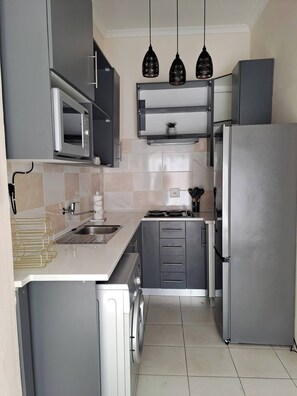 Fridge, microwave, stovetop, cookware/dishes/utensils