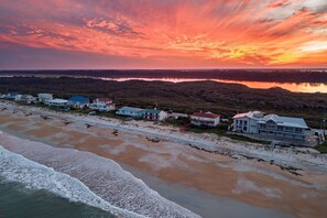 A coastal area with houses along the beach, a clear view of the ocean, and a sunset sky. - Oceanfront 4BR | Direct Beach Access | Chiminea, Ponte Vedra, Small Dog | 2 Decks, Hammocks, Sleeps (Ponte Vedra Beach)