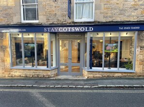Welcome to STAY COTSWOLD, a charming holiday cottage with a traditional facade and inviting entrance.