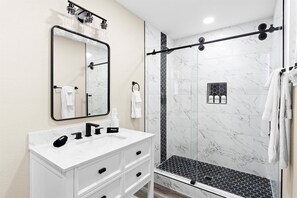 Shower, hair dryer, towels, shampoo