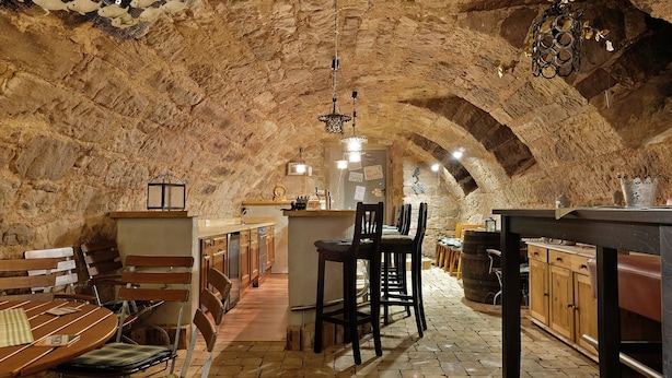 A rustic stone interior with a bar area, wooden furniture, and a stone ceiling. - 'Doppelzimmer Ohne Balkon 26' with Shared Garden and Wi-Fi (St. Georgen)