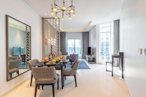 Enjoy a meal at the dining table, surrounded by a comfortable seating area and a large mirror.