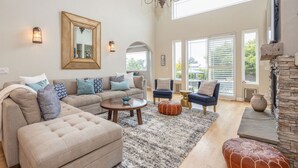 A spacious living room with a large sectional sofa, a coffee table, and a fireplace. - 2 Blocks to ocean, steps to beach, ocean view,  coastal trail, BBQ (Half Moon bay)